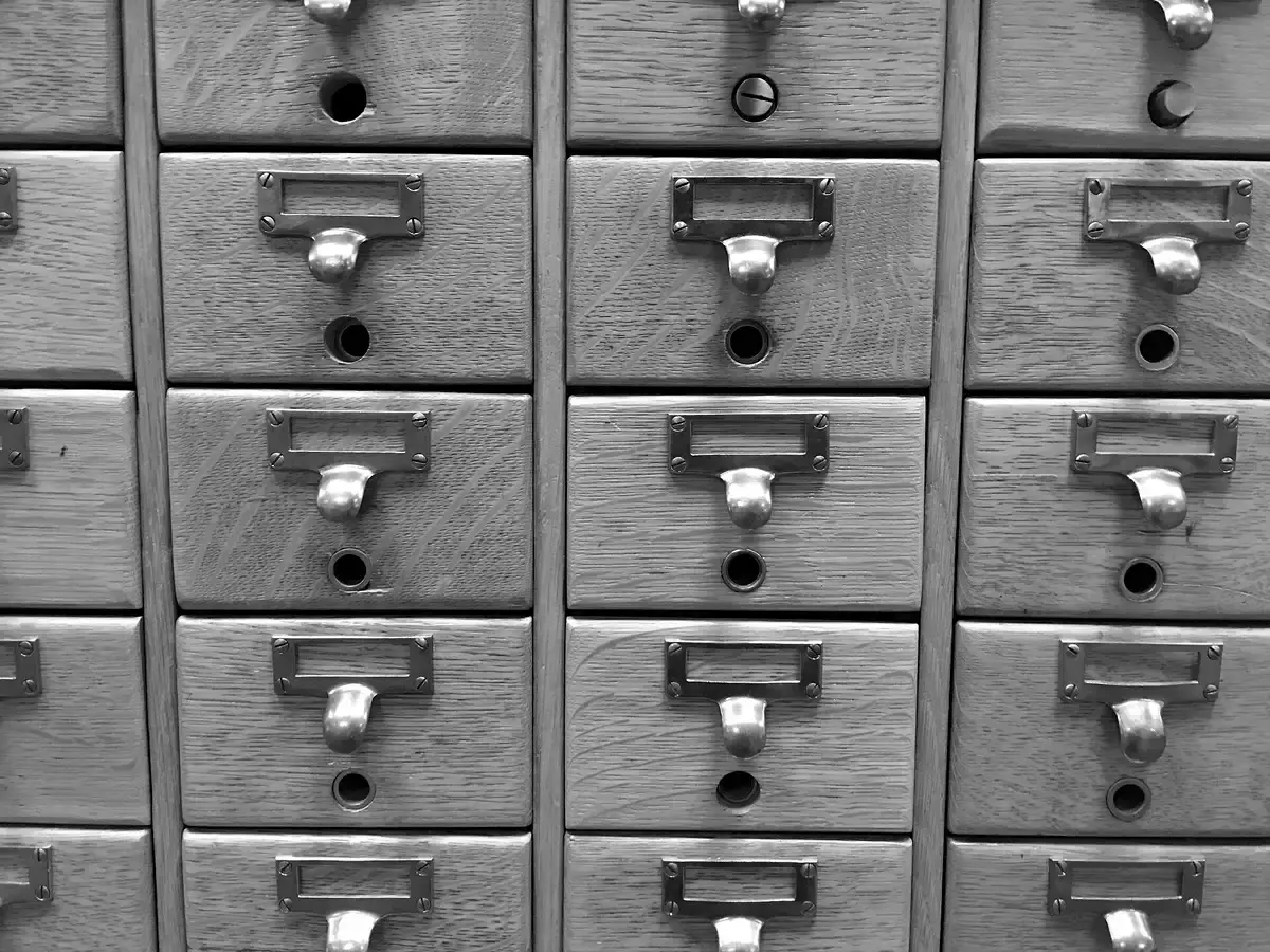 Rows of wooden card index drawers with brass label holders